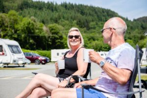 Couple enjoying a drink at Riverside Touring Park
