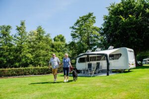 Guests walking away from caravan at Stanmore Hall Touring Park